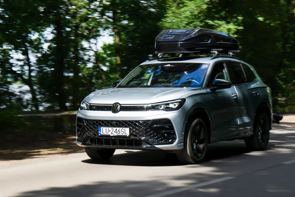 Box dachowy Inter Pack Monsun L czarny metalik 550L – zamontowany na dachu kompaktowego auta miejskiego, ujęcie z przodu na tle ulicy
